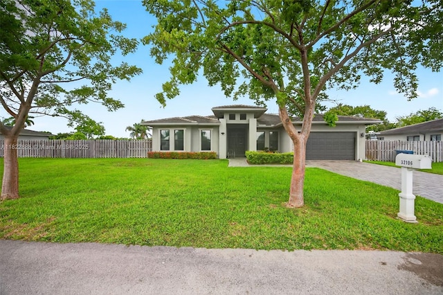 32106 SW 199th Pl, Homestead, FL 33030 - prairie-style home with an attached garage, driveway, and stucco siding