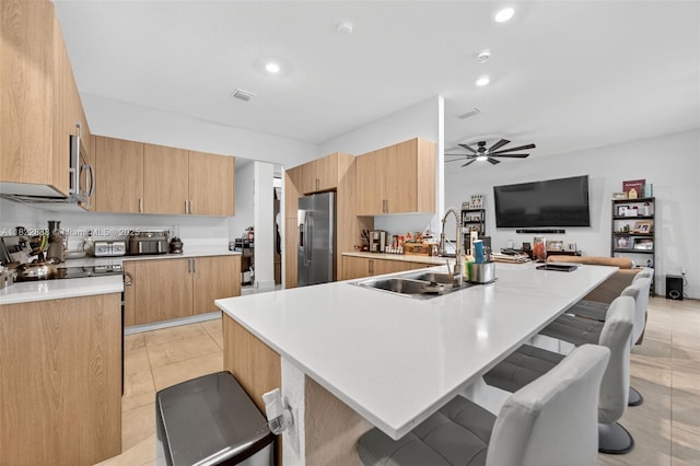 32106 SW 199th Pl, Homestead, FL 33030 - kitchen with appliances with stainless steel finishes, a breakfast bar, ceiling fan, light countertops, and recessed lighting