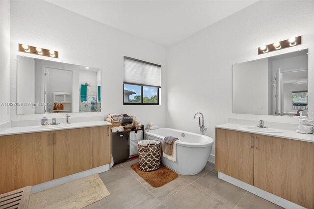 32106 SW 199th Pl, Homestead, FL 33030 - full bathroom featuring two vanities, a freestanding bath, and tile patterned flooring