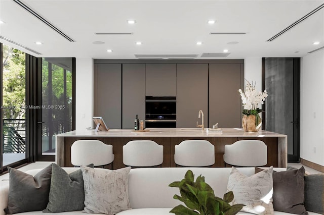 3571 Fair Isle St, Miami, FL 33133 - kitchen with gray cabinets, floor to ceiling windows, modern cabinets, a spacious island, and open floor plan