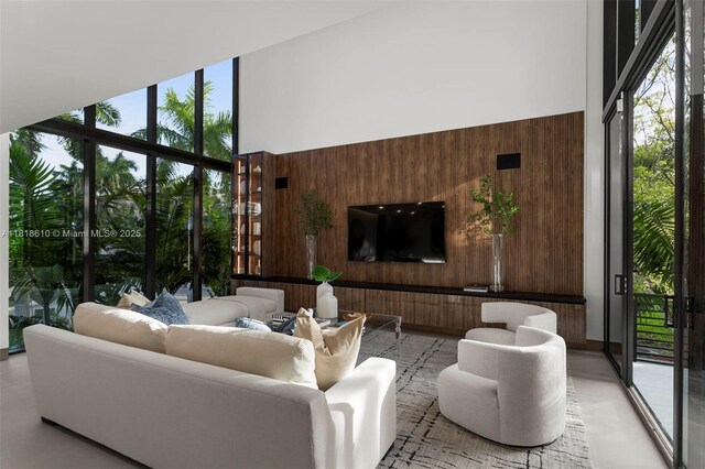 3571 Fair Isle St, Miami, FL 33133 - living room with wooden walls, healthy amount of natural light, floor to ceiling windows, and a high ceiling