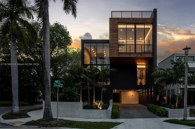 3571 Fair Isle St, Miami, FL 33133 - view of front of house with a balcony, decorative driveway, and a garage