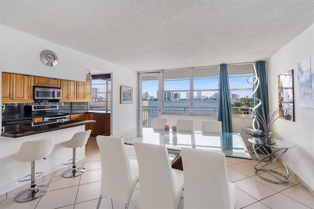 251 174th St Unit 218, Sunny Isles Beach, FL 33160 - dining space with a textured ceiling and light tile patterned floors