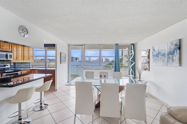 251 174th St Unit 218, Sunny Isles Beach, FL 33160 - dining area featuring a textured ceiling and light tile patterned flooring