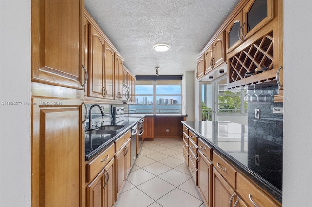 251 174th St Unit 218, Sunny Isles Beach, FL 33160 - kitchen featuring dark stone counters, brown cabinets, and a textured ceiling
