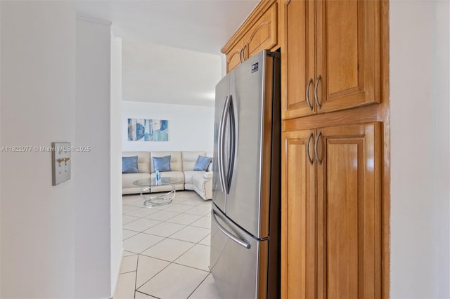 251 174th St Unit 218, Sunny Isles Beach, FL 33160 - kitchen with freestanding refrigerator, light tile patterned floors, open floor plan, and brown cabinetry