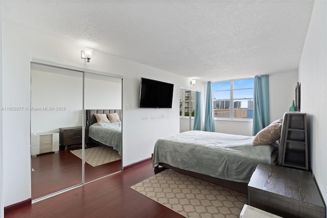 251 174th St Unit 218, Sunny Isles Beach, FL 33160 - bedroom with wood finished floors, a textured ceiling, and a closet