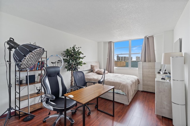 251 174th St Unit 218, Sunny Isles Beach, FL 33160 - bedroom featuring dark wood-style floors and a textured ceiling