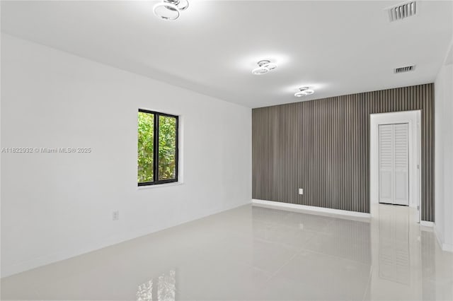 1640 NE 183rd St, North Miami Beach, FL 33179 - unfurnished room featuring tile patterned floors and an accent wall