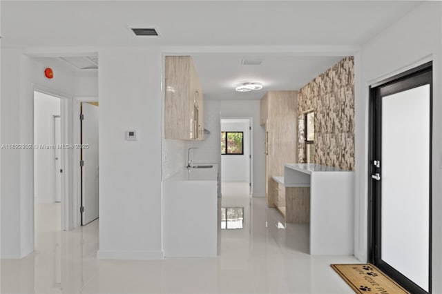 1640 NE 183rd St, North Miami Beach, FL 33179 - corridor with light tile patterned floors and a sink