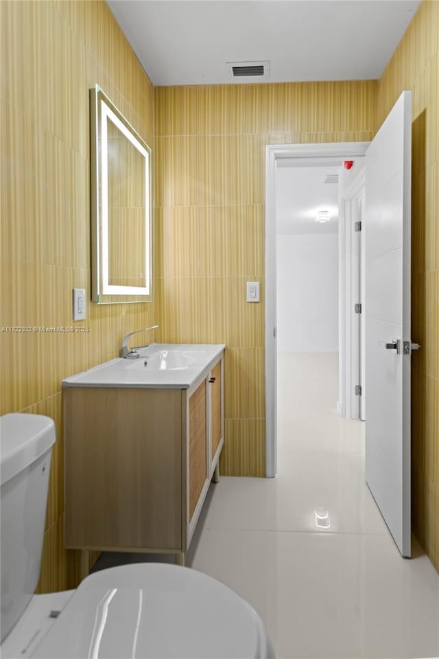 1640 NE 183rd St, North Miami Beach, FL 33179 - half bathroom with vanity, tile walls, and tile patterned floors