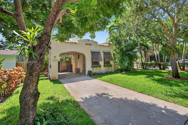 1314 SE 1st Ave, Fort Lauderdale, FL 33316 - mediterranean / spanish home featuring stucco siding, driveway, and a front lawn