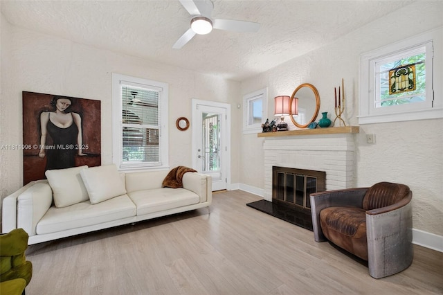 1314 SE 1st Ave, Fort Lauderdale, FL 33316 - living area with a textured ceiling, wood finished floors, a textured wall, ceiling fan, and a fireplace