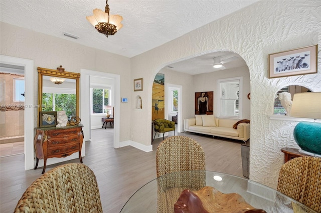 1314 SE 1st Ave, Fort Lauderdale, FL 33316 - living room featuring arched walkways, wood finished floors, and a textured ceiling