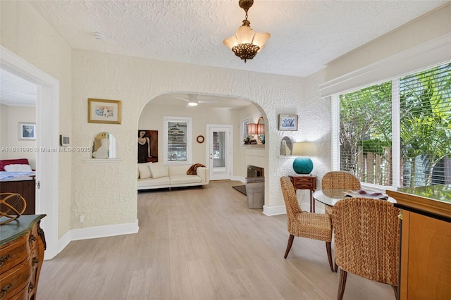 1314 SE 1st Ave, Fort Lauderdale, FL 33316 - sitting room featuring arched walkways, light wood-type flooring, a textured ceiling, and a textured wall