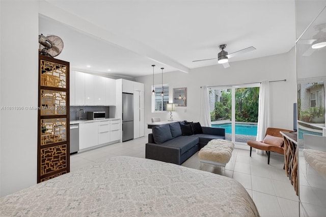 1314 SE 1st Ave, Fort Lauderdale, FL 33316 - bedroom with access to exterior, stainless steel refrigerator, light tile patterned flooring, and recessed lighting