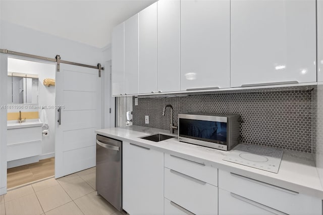 1314 SE 1st Ave, Fort Lauderdale, FL 33316 - kitchen featuring appliances with stainless steel finishes, light countertops, and white cabinetry