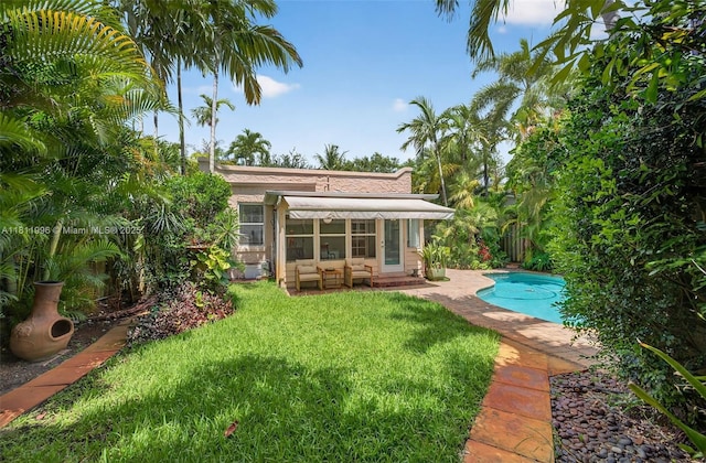 1314 SE 1st Ave, Fort Lauderdale, FL 33316 - rear view of house with a yard, an outdoor pool, and a patio area