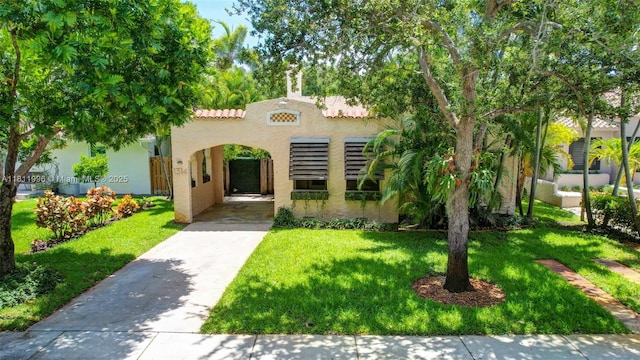 1314 SE 1st Ave, Fort Lauderdale, FL 33316 - mediterranean / spanish home featuring stucco siding, a front lawn, and driveway