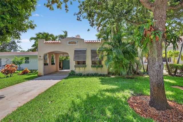 1314 SE 1st Ave, Fort Lauderdale, FL 33316 - mediterranean / spanish-style home featuring stucco siding, a front yard, driveway, and a tile roof