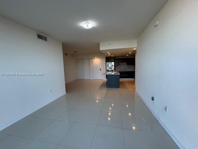 7875 NW 107th Ave Unit 410, Doral, FL 33178 - spare room featuring light tile patterned flooring and baseboards