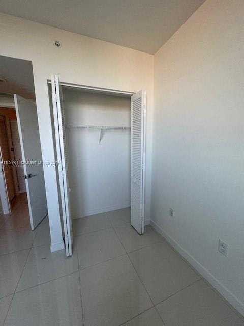 7875 NW 107th Ave Unit 410, Doral, FL 33178 - unfurnished bedroom with a closet and light tile patterned floors