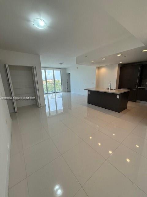 7875 NW 107th Ave Unit 410, Doral, FL 33178 - unfurnished living room with light tile patterned flooring and recessed lighting