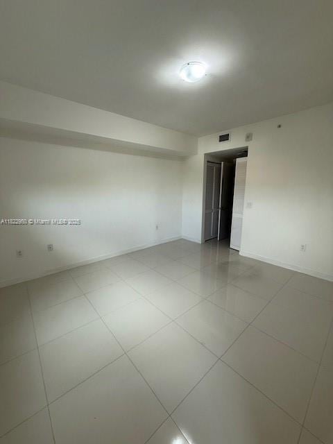 7875 NW 107th Ave Unit 410, Doral, FL 33178 - empty room featuring baseboards and light tile patterned flooring