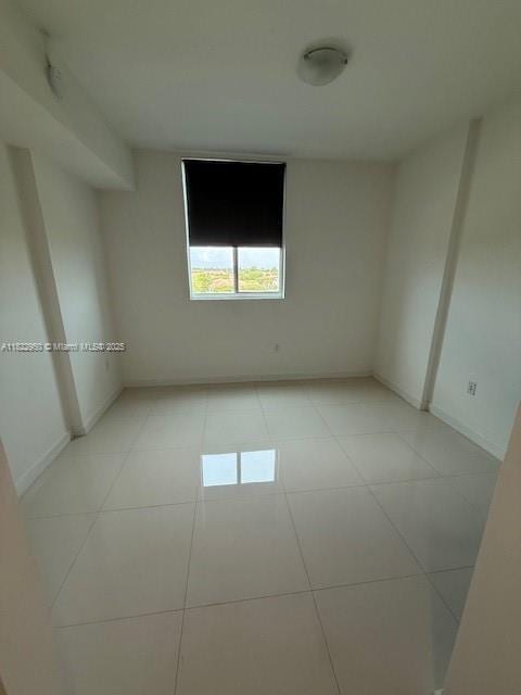 7875 NW 107th Ave Unit 410, Doral, FL 33178 - spare room featuring light tile patterned flooring