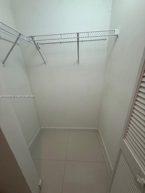 7875 NW 107th Ave Unit 410, Doral, FL 33178 - spacious closet featuring tile patterned floors