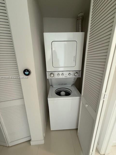 7875 NW 107th Ave Unit 410, Doral, FL 33178 - laundry area with stacked washer and clothes dryer and light tile patterned floors