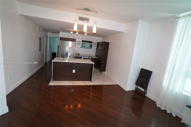 1900 N Bayshore Dr Unit 2510, Miami, FL 33132 - kitchen featuring appliances with stainless steel finishes, light wood-type flooring, tasteful backsplash, dark brown cabinets, and light countertops