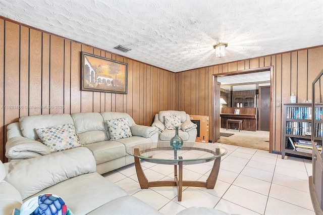 2390 Service Rd, Opa-Locka, FL 33054 - living area with wooden walls, a textured ceiling, light colored carpet, and light tile patterned floors