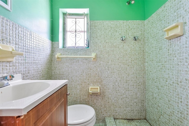 2390 Service Rd, Opa-Locka, FL 33054 - bathroom featuring tile walls, vanity, and a wainscoted wall