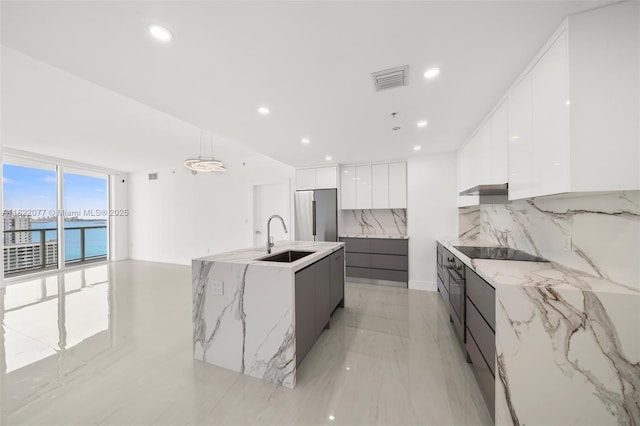 1900 N Bayshore Dr Unit 2104, Miami, FL 33132 - kitchen with modern cabinets, decorative backsplash, stainless steel appliances, white cabinetry, and under cabinet range hood