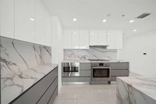 1900 N Bayshore Dr Unit 2104, Miami, FL 33132 - kitchen featuring appliances with stainless steel finishes, modern cabinets, gray cabinetry, light stone counters, and recessed lighting