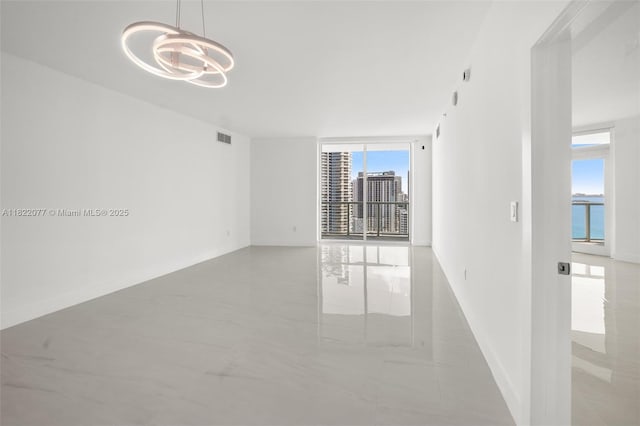 1900 N Bayshore Dr Unit 2104, Miami, FL 33132 - empty room featuring a chandelier and floor to ceiling windows