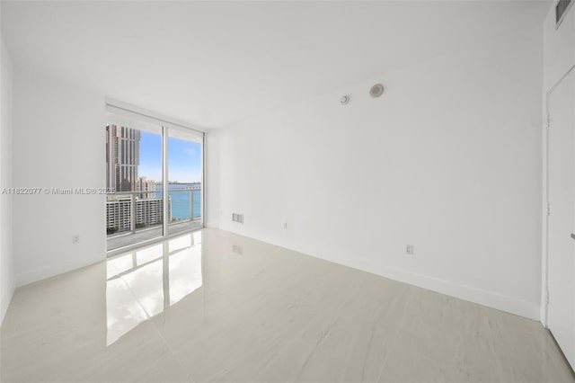 1900 N Bayshore Dr Unit 2104, Miami, FL 33132 - empty room featuring floor to ceiling windows and a water view