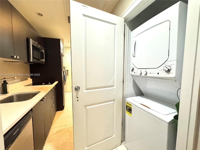5300 NW 87th Ave Unit 1507, Doral, FL 33178 - laundry area with stacked washer / dryer and light tile patterned floors