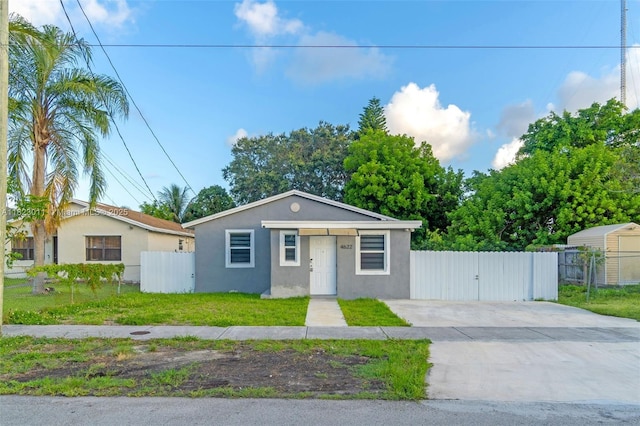 4622 SW 23rd St, West Park, FL 33023 - view of front of home with stucco siding, driveway, and a gate