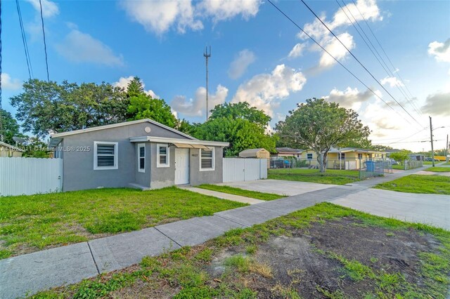 4622 SW 23rd St, West Park, FL 33023 - bungalow-style home featuring stucco siding, a fenced front yard, driveway, and a gate
