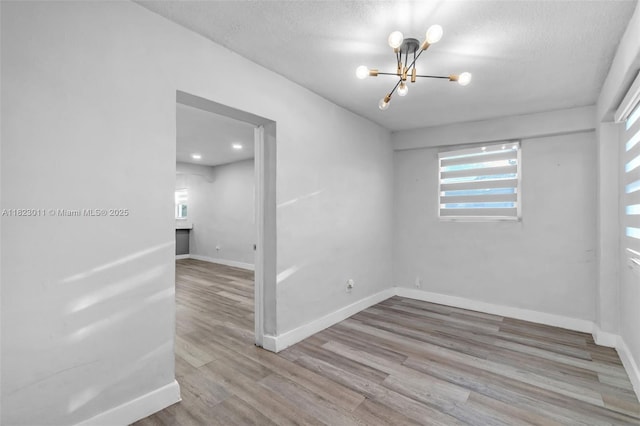 4622 SW 23rd St, West Park, FL 33023 - unfurnished room featuring a chandelier, wood finished floors, and a textured ceiling