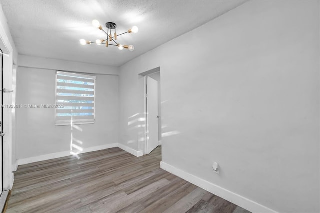 4622 SW 23rd St, West Park, FL 33023 - spare room featuring a chandelier, wood finished floors, and a textured ceiling