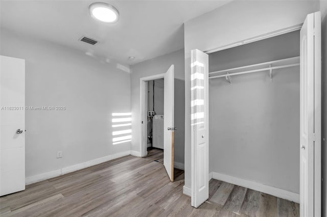 4622 SW 23rd St, West Park, FL 33023 - unfurnished bedroom featuring a closet, wood finished floors, and washer / dryer