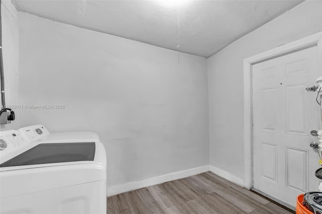 4622 SW 23rd St, West Park, FL 33023 - laundry room with washing machine and dryer, wood finished floors, and a textured ceiling