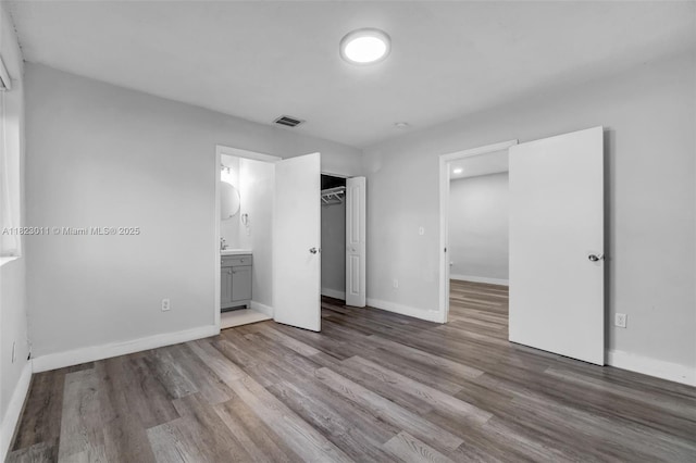 4622 SW 23rd St, West Park, FL 33023 - unfurnished bedroom with wood finished floors, ensuite bathroom, and a closet