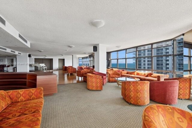 6423 Collins Ave Unit 1605, Miami Beach, FL 33141 - building lobby featuring a textured ceiling and a water view