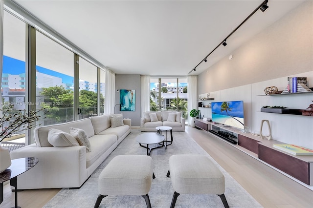 300 Collins Ave Unit 3D, Miami Beach, FL 33139 - living room with rail lighting, expansive windows, wood finished floors, and a view of city