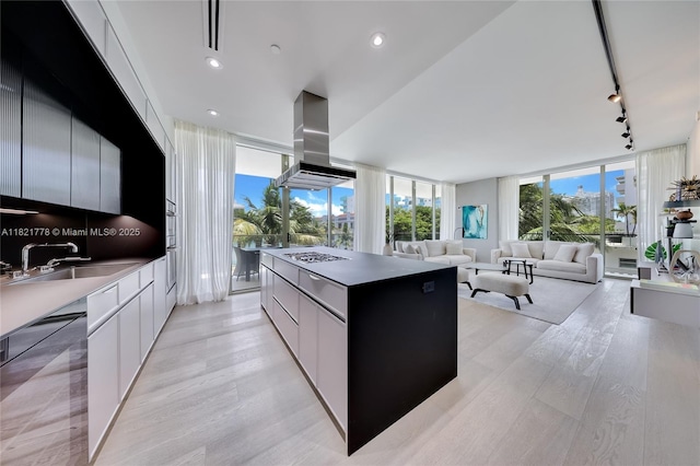 300 Collins Ave Unit 3D, Miami Beach, FL 33139 - kitchen featuring island range hood, dishwasher, rail lighting, a kitchen island, and modern cabinets