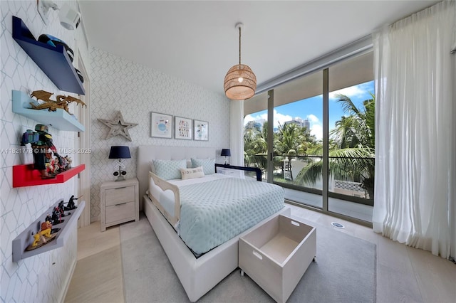 300 Collins Ave Unit 3D, Miami Beach, FL 33139 - bedroom with wallpapered walls, access to exterior, floor to ceiling windows, and a water view
